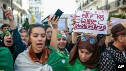 FILE: In this Tuesday, April 9, 2019 photo, Algerian students take part in a demonstration against the country's leadership in Algiers, Algeria.