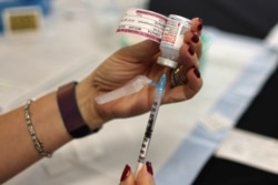 FILE - A nurse draws a Moderna coronavirus disease (COVID-19) vaccine, in Los Angeles