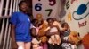 FILE - Ugandan children, orphans among them, are seen at a clinic in Kampala, Uganda, in a Aug. 3, 2012, photo.