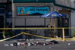 Shoes are piled in the rear of Ned Peppers Bar at the scene after a mass shooting in Dayton, Ohio, Aug. 4, 2019.