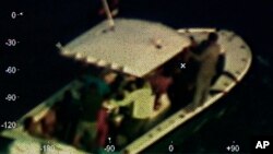 In this photo provided by the Coast Guard, a Coast Guard Air Station Miami HC-144 Ocean Sentry aircrew takes a photo of a disabled vessel that the aircrew located 130 nautical miles (210 kilometers) off Mexico's Yucatan Peninsula on Sunday, April 14, 2019.