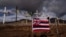 FILE - A Hawaiian flag and crosses honoring the victims killed in a recent wildfire are posted along the Lahaina Bypass in Lahaina, Hawaii, Aug. 21, 2023. 