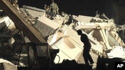 Rescuers search for victims in the debris of a hospital after the earthquake in the southwestern province of Sichuan, China, on May 12, 2008.