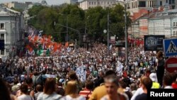 Participants march with flags and placards during an anti-government protest in Moscow 