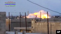 Smoke rising after a Russian airstrike hit buildings in the town of Latamna in the area of Hama in Eastern Syria, Oct. 7, 2015.