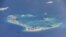 Chinese dredging vessels are purportedly seen the waters around Mischief Reef in the disputed Spratly Islands in the South China Sea in this video image taken by a P-8A Poseidon surveillance aircraft provided by the U.S. Navy, May 21, 2015. 