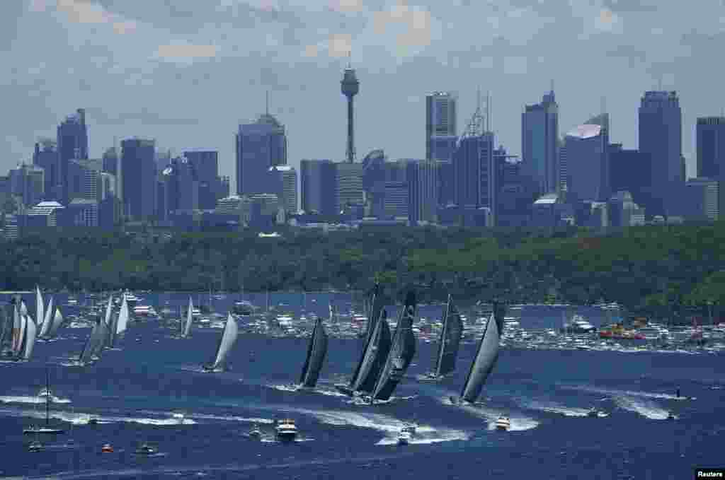 The field of yachts head down Sydney Harbor at the start of the annual Sydney to Hobart yacht race, Australia.