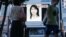 A portrait of Japanese journalist Mika Yamamoto is shown on a large monitor screen in Tokyo Tuesday, Aug. 21, 2012 during a TV news broadcast reporting her death in Syria. 