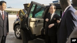 FILE -- In this file photo taken Thursday, Oct. 30, 2014, North Korea's ceremonial leader Kim Yong Nam, center-right, the head of North Korea's parliament, arrives for a visit to Uganda's parliament in Kampala, Uganda. North Korean weapons barred by U.N. sanctions ended up in the hands of U.N. peacekeepers in Africa, a confidential report says. That incident and others in more than a half-dozen African nations show how North Korea, despite facing its toughest sanctions in decades, continues to avoid them on the world's most impoverished continent with few repercussions.