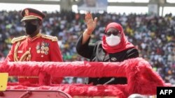 Tanzania’s President Samia Suluhu Hassan (R) attends the 60th anniversary of independence day ceremony at the National Stadium in Dar es Salaam, Tanzania, on December 9, 2021.