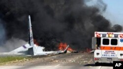 Flames and smoke rise from an Air National Guard C-130 cargo plane after it crashed near Savannah, Ga., May 2, 2018.