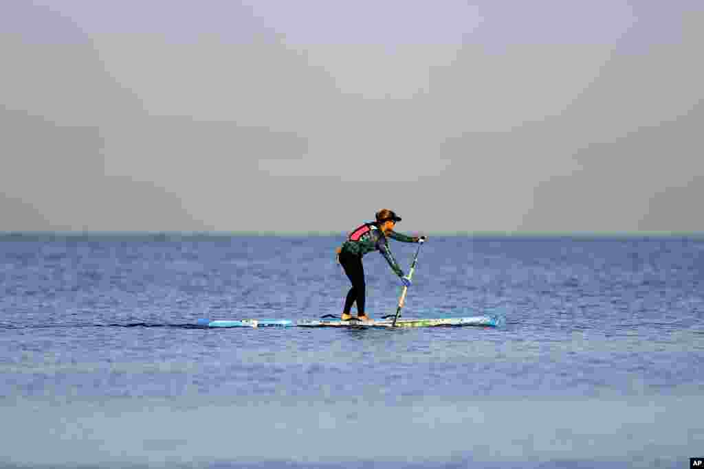 Stand-up paddle boarder, Victoria Burgess, 33, of the United States, paddles out at the beginning of her attempt to cross the Florida Straits, at Hemingway Marina in Havana, Cuba.