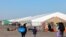 FILE - Migrants who arrived a few days ago from Eagle Pass, Texas, walk to the shelters at Floyd Bennett Field in the Brooklyn borough of New York on Feb. 3, 2024.