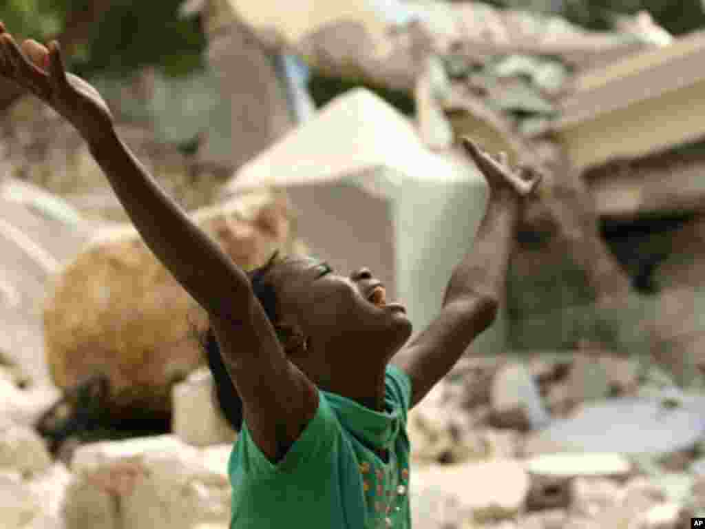 Cindy Terasme screams after seeing the feet of her dead 14-year-old brother Jean Gaelle Dersmorne in the rubble of the collapsed St. Gerard School in Port-au-Prince, Haiti, Thursday, Jan. 14, 2010. A 7.0-magnitude earthquake hit Haiti Tuesday. (AP Photo/
