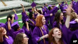 FILE - Graduates throw their mortarboards into the air in celebration after receiving their diplomas, following the commencement ceremony at Boulder High School, in Boulder, Colo. on Saturday, May 18, 2013. (AP Photo/Brennan Linsley)