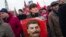 FILE - Communist party supporters hold portraits of Stalin as they line up to place flowers on his grave in Red Square, outside the Kremlin wall, to mark the 64th anniversary of his death in Moscow, Russia, March 5, 2017. Polls show that Stalin is being increasingly seen by Russian as less a villain and more of an "effective manager" and a symbol of Soviet-Russian power.