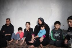 Abeel, 36, with her children who all fled from Idlib a week ago during the night, are seen in Raqqa, Syria, Feb. 23, 2020. (Heather Murdock/VOA)