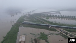 Foto dari udara yang menunjukkan wilayah di Kota Sinuiju di Korea Utara terendam banjir. (Foto KCNA via KNS/AFP)