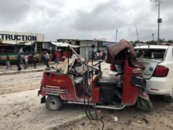 A wreckage of a rickshaw and a car are seen at the scene of an explosion in Mogadishu, Somalia, July 13, 2020.