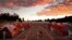 FILE - A boy plays as the sun sets over donated tents for homeless families lined up on a parking lot in the city-sanctioned encampment in San Diego, Nov. 8, 2017. A parking lot in San Diego's famed Balboa Park has acted for the past two months as an unusual triage center. Scores of tents, mobile medical units, portable toilets and showers were brought in to meet the needs of hundreds of people affected by a societal problem that has bloomed into a deadly disaster: homelessness.