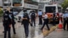 Police officers stand guard outside a court in Hong Kong, Aug. 19, 2021. Seven Hong Kong pro-democracy activists have reportedly pleaded guilty Thursday to organizing and inciting others to take part in an unauthorized assembly held in 2019.