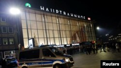 A police car is seen on the empty square in front of the main railways station following New Year celebrations in Cologne, Germany, Jan. 1, 2017.