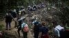 FILE - Migrants walk across the Darien Gap from Colombia to Panama in hopes of reaching the United States, on May 9, 2023.