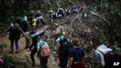 FILE - Migrants walk across the Darien Gap from Colombia to Panama in hopes of reaching the United States, on May 9, 2023.