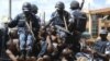 Rioters sit on the back of a police truck after their arrest in the capital city Kampala, Uganda, after riots broke out, April 29, 2011