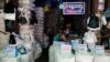 ရန်ကုန်မြို့ ဈေးတခုမှာ မျက်နှာဖုံးတပ် ဈေးရောင်းနေသူတဦး။ (ဧပြီ ၂၁၊ ၂၀၂၀)