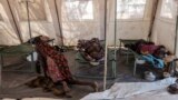 FILE - Patients suffering from cholera receive treatment inside a tent converted into a temporary field hospital near the remote village of Dor in the Awerial county in south-central Sudan, April 28, 2017. 