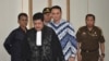 Jakarta Governor Basuki "Ahok" Tjahaja Purnama, center, is escorted by prosecutors as enters the court room for his sentencing hearing in Jakarta, Indonesia, May 9, 2017.