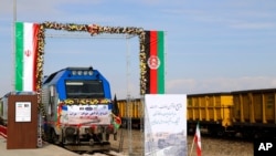 A train prepares to move during the inauguration of a 140-kilometer (90-mile) line running from eastern Iran into western Afghanistan, at a railroad station in Khaf, Iran, Dec. 10, 2020.