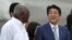 Japan's Prime Minister Shinzo Abe, center, talks to Salvador Antonio Valdes Mesa, a member of the Political Bureau of the Central Committee of the Communist Party of Cuba and vice president of the Council of State of Cuba, upon his arrival at Jose Marti International Airport in Havana, Cuba, Sept. 22, 2016. 