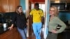 Cabrel Ngounou, center, a refugee from Cameroon, talks with his sponsors, Lori Ostlund, left, and Anne Raeff, in their home in San Francisco on Sept. 17, 2024.