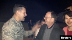 FILE - Jeffrey Fowle and his wife, Tatyana, are greeted by U.S. Air Force Col. John Devillier upon arrival at Wright-Patterson Air Force Base in Ohio after his release in North Korea, Oct. 22, 2014. 