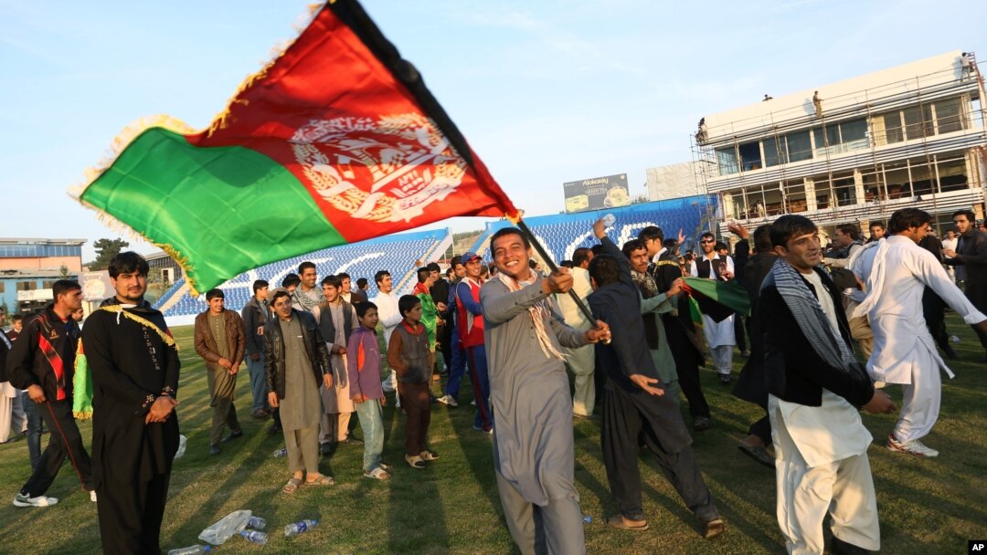 FILE - Afghan cricket fans celebrate the victory of the national cricket team over Zimbabwe as the team returns and celebrates in Kabul, Afghanistan, Oct. 30, 2015.