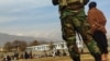 FILE - Taliban security personnel keep watch ahead of the court flogging of women and men at a football stadium in Charikar city of Parwan province, Dec. 8, 2022. 