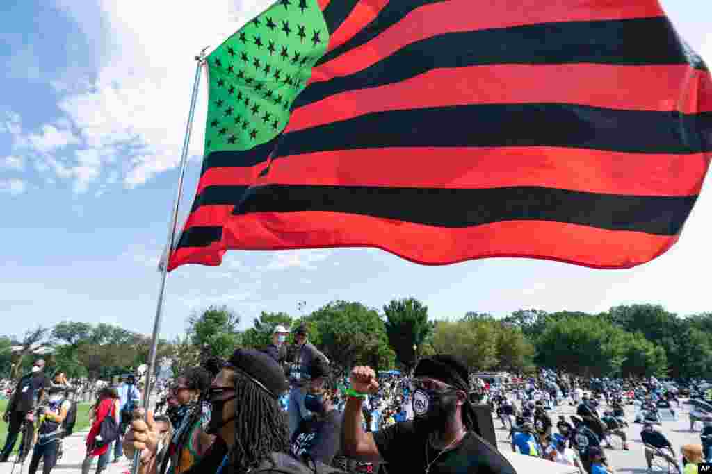 People attend the March on Washington, Aug. 28, 2020, at the Lincoln Memorial in Washington, on the 57th anniversary of the Rev. Martin Luther King Jr.&#39;s &quot;I Have A Dream&quot; speech.