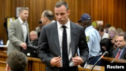 Olympic and Paralympic track star Oscar Pistorius arrives in court ahead of his trial at the North Gauteng High Court in Pretoria, March 3, 2014.