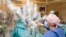 FILE - Surgeons use the robot da Vinci to aid a hernia operation, at the University Hospital Geneva, in Geneva, Switzerland, Nov. 13, 2008.  