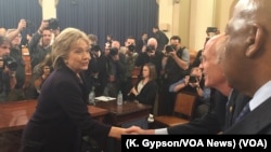 Former U.S. Secretary of State Hillary Clinton greets people following her morning testimony before the House Select Committee on Benghazi on Capitol Hill, Oct. 22, 2015. 