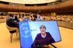 United Nations High Commissioner for Human Rights Michelle Bachelet is seen on a screen delivering her speech remotely at the opening of a U.N. Human Rights Council emergency meeting in Geneva, May 27, 2021.