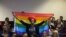 An activist holds up a rainbow flag to celebrate inside Botswana High Court in Gaborone on June 11, 2019. Botswana's Court ruled on June 11 in favour of decriminalising homosexuality, handing down a landmark verdict greeted with joy by gay rights…