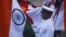 An Indian Navy soldier holds an Indian national flag during a dress rehearsal ahead of Navy Day celebrations in Mumbai, December 2, 2011. 