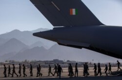Indian soldiers disembark from a military transport plane at a forward airbase in Leh, in the Ladakh region, Sept. 15, 2020.