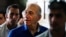 FILE - Former Israeli Prime Minister Ehud Olmert (C) leaves Tel Aviv District Court.