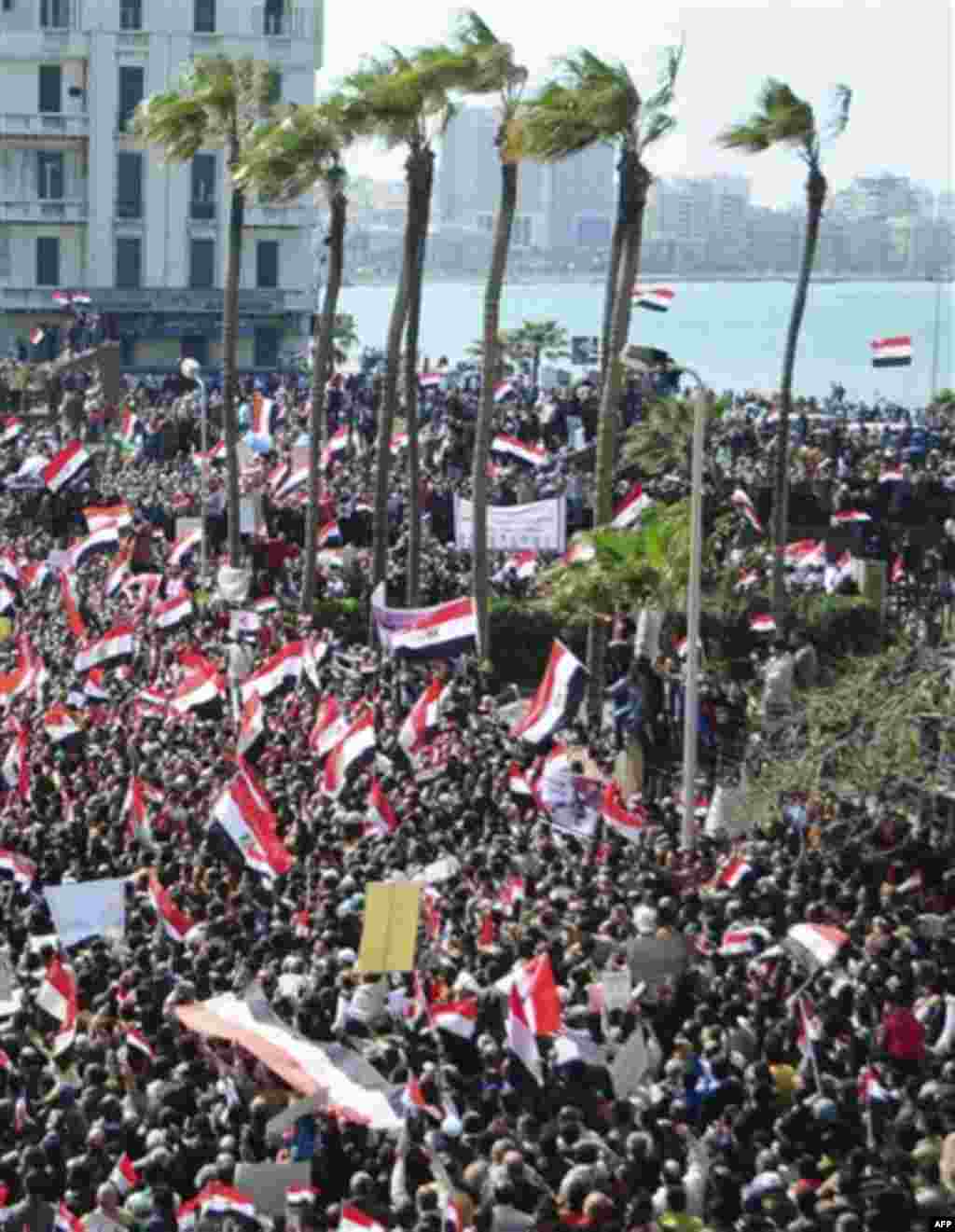 Thousands of Egyptian anti-government protesters march Alexandria, Egypt, Friday, Feb. 11, 2011. Egypt's military threw its weight Friday behind President Hosni Mubarak's plan to stay in office through September elections while protesters fanned out to th