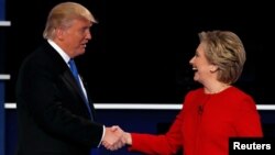 Republican U.S. presidential nominee Donald Trump and Democratic U.S. presidential nominee Hillary Clinton shake hands at the end of their first presidential debate at Hofstra University in Hempstead, New York, U.S., September 26, 2016. 