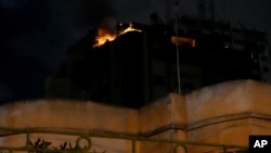 Fire burns at an apartment of an Islamic Jihad commander for northern Gaza, following Israeli airstrikes in Gaza City, May 9, 2023.